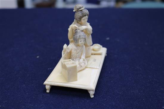 A Japanese figural ivory okimono, width 10cm